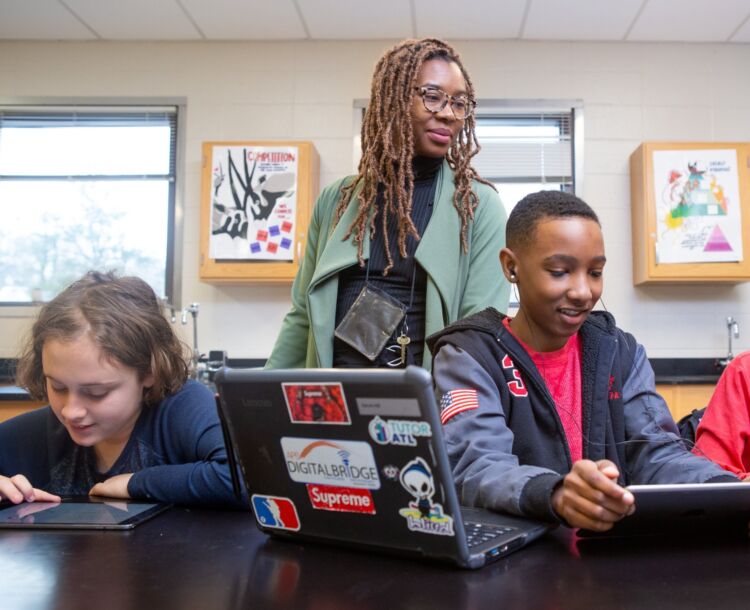 teacher with students in computer lab