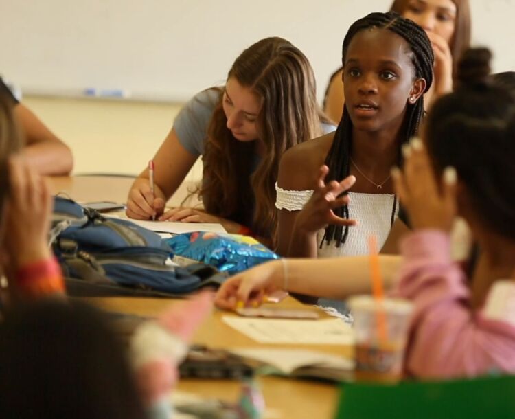 CRE stories photo of student speaking seated in class